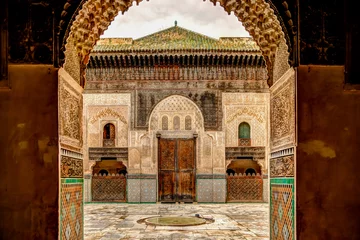 Zelfklevend Fotobehang Intricate tile patterns, metal work and plaster carvings adorning  building exteriors in Fez Morocco © Torval Mork