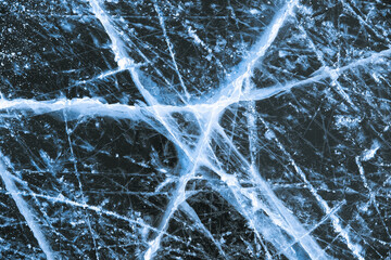 Cracked natural lake ice texture close up