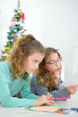 two sisters are drawing together