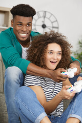 smiling couple playing video games