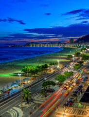 Night view of Copacabana beach and Avenida Atlantica in Rio de Janeiro, Brazil. Copacabana beach is...