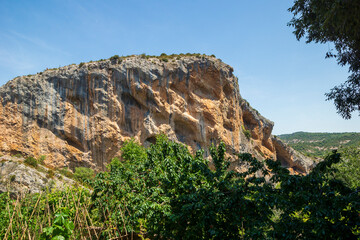 Fototapeta na wymiar vulture nests on the mountain wall in a natural landscape in the area of Alquezar, Huesca, Spain.