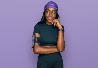 Young african american woman wearing sportswear serious face thinking about question with hand on...