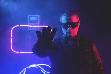 Futuristic man is showing a stop gesture in the neon lights background.