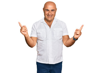 Naklejka premium Mature middle east man with mustache wearing casual white shirt smiling confident pointing with fingers to different directions. copy space for advertisement