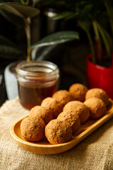 Healthy homemade paleo, hight protein chocolate energy balls with nuts anddates. Raw vegetarian sweets. Sugar free, gluten free.Tasty chocolates, confectionery concept