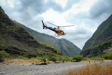 Fototapeta na wymiar Helicopter supplying small villages in Mafate, la Réunion Island with food, medic, post mail, raw material and building materials.