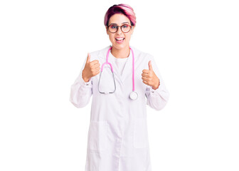 Young beautiful woman with pink hair wearing doctor uniform success sign doing positive gesture...