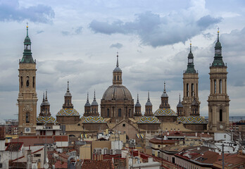 Fototapeta na wymiar Towers of a Basilica between the houses