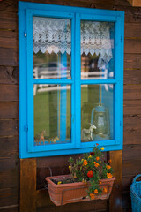 A lodge for the rest. Window on old wooden house. Traditional rural wooden house. Cabin in summer. Tourist attraction.