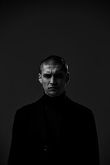 Brutal handsome angry guy security or criminal frowning, black and white studio male portrait with...