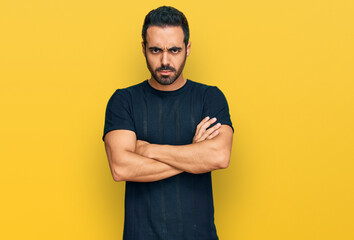 Young hispanic man wearing casual clothes skeptic and nervous, disapproving expression on face with...