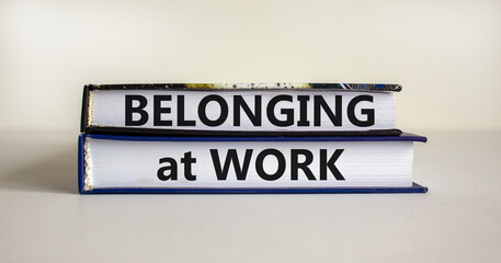 Belonging at work symbol. Books with words 'Belonging at work' on beautiful white background. Business, belonging at work concept. Copy space.