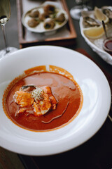 macro photo of a white plate with tomato cream soup 