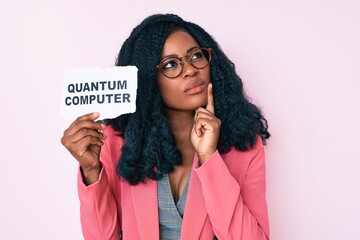 Beautiful african woman holding quantum computer banner serious face thinking about question with...