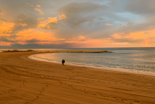 Couple Walkinkg over the Sand and Rainbow