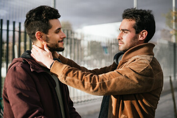 Two gay guys staring at each other in an amorous way.