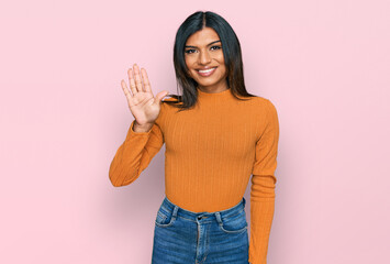 Young latin transsexual transgender woman wearing casual clothes showing and pointing up with fingers number five while smiling confident and happy.