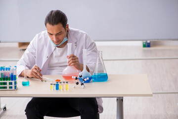 Young male chemist working in the lab