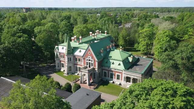 Manor of the Kozel-Poklevsky. The palace and park complex. Krasny Bereg Red Beach. Zhlobin district.  Two-story building. Red brick walls, green roof. View from above
