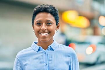 Young african american girl smiling happy standing at the city.