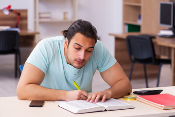 Young male student preparing for exam at home