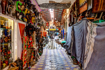 Fototapeta premium Marrakech, Morocco - April 5, 2019: The buildings and busy walkways and shops in the souks of Marrakech Morocco.