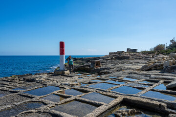 Portrait of brunette woman with green t-shirt in salt flats in Malta