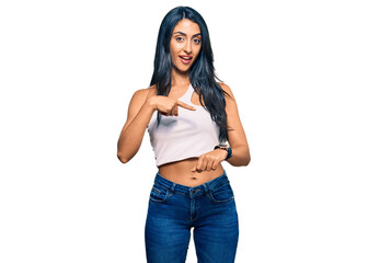 Beautiful hispanic woman wearing casual clothes in hurry pointing to watch time, impatience, upset and angry for deadline delay