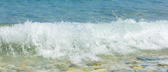 Sea wave and pebble. Summer vacation concept. Sea wave with foam. Travel concept