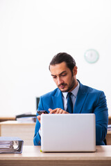 Young male employee and too many work in the office