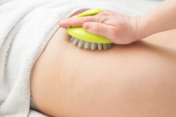 Masseur makes anticellulite massage young woman using massager. Massage with massager to prevent cellulite