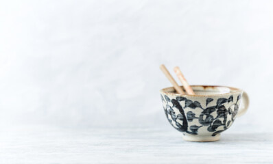 Traditional, handcrafted ceramic on bright wooden background. Copy space.	