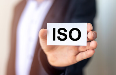 ISO acronym in male hands. Concept of standards and quality