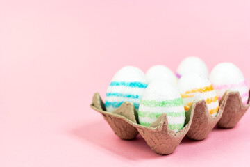 Colorful Easter eggs on a pink background. Copy space. Celebrating Easter