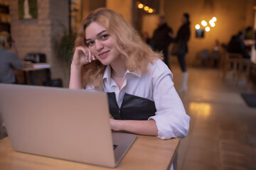 Attractive woman working on laptop in the cafe