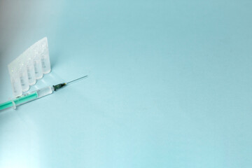 Medical vials for injection, syringe for injection, mask gloves on a blue background. Admission vaccination, flu shot