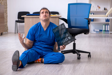 Young male doctor radiologist being unhappy after night shift