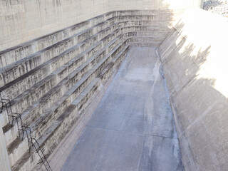 Dam spillway, concrete structure - part of the dam for draining excess water from a reservoir in...