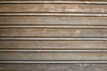 the wall is covered with clapboard. wooden background.