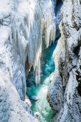 Fototapeta na wymiar Partnachklamm Gorge in winter - frozen waterfalls over blue water