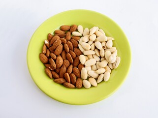 scaled white and raw brown almonds close up