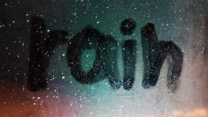 window with the inscription rain.
Inscription written on wet window after rain