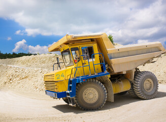 A large quarry dump truck loaded with rock.