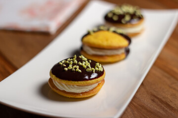 Obraz na płótnie Canvas Bouche. Homemade stuffed desserts with pistachio crunches on top.