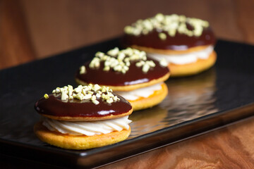 Bouche. Homemade stuffed desserts with pistachio crunches on top.