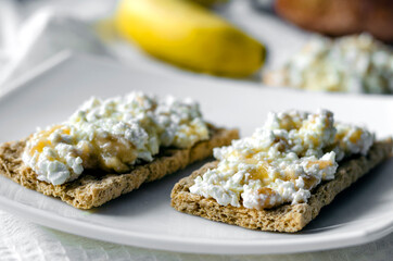 Sandwich with cottage cheese, honey and banana on a diet bread