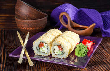Sushi rolls with salmon in sesame