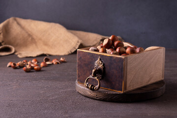 Nuts in a wooden box on a blue background. Horizontal orientation. View from above.
