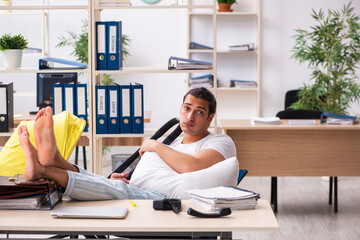 Young male employee looking after newborn at workplace